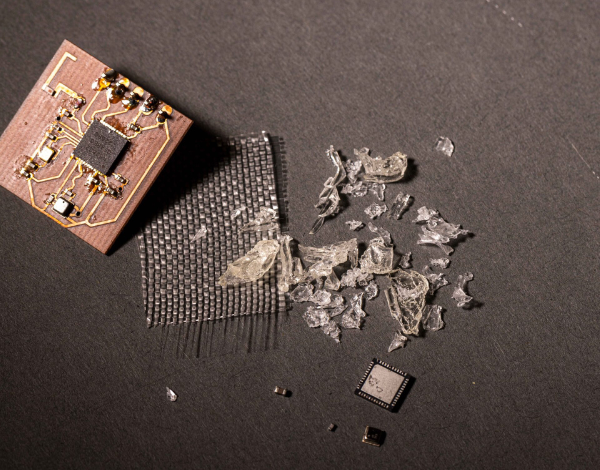 Layers of a dissembled printed circuit board including circuits, mesh and acrylic